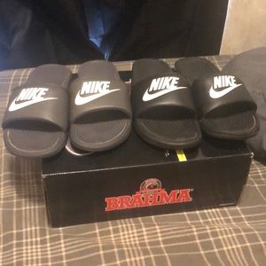 Pair of black and pair of gray used Nike sandals. Sz 10